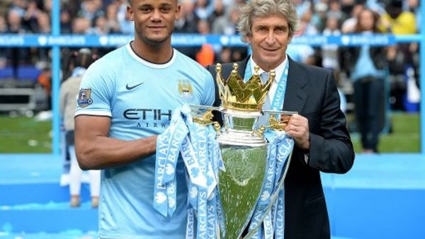 Manchester City's players captain Vincent Kompany holds the Cup and celebrates with team mates after being crowned Premier League Champions during the English Premier League soccer match between Manchester City and West Ham United at the Etihad Stadi