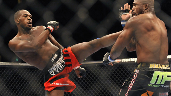Jon Jones, left, of Endicott, N.Y., gets in a kick to the head of Rampage Jackson, of Irvine, Calif., during the first round of their UFC Light Heavyweight title bout, Saturday, Sept. 24, 2011, in Denver. (AP Photo/ Jack Dempsey )