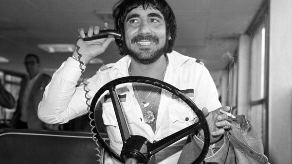 Keith Moon, drummer for the pop band The Who, at London's Heathrow Airport, takes the wheel of an airport luggage transporter. He was flying in from LA to join the group for a tour of England and France.