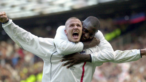 FILE - This is a Saturday, Oct. 6, 2001 file photo of England's captain David Beckham, left, as he is congratulated by teammate Emile Heskey after scoring their second goal against Greece during their 2002 World Cup qualifying match at Old Trafford Manche