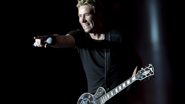 Guitarist and singer Chad Kroeger, of the Canadian rock band Nickelback, acknowledges fans as he performs during the annual Rock in Rio music festival in Rio de Janeiro, Brazil, Friday, Sept. 20, 2013. More than 80 thousand people a day are expected to at