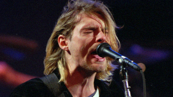 FILE - This Dec. 13, 1993 file photo shows Kurt Cobain of the Seattle band Nirvana performing in Seattle, Wash. Nirvana, which changed music and fashion in the 1990s with the punk rock-inspired grunge sound, is joining the Rock and Roll Hall of Fame in a 