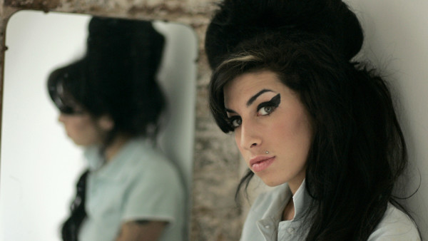 FILE - In this Feb. 16, 2007 file photo, British singer Amy Winehouse poses for photographs after being interviewed by The Associated Press at a studio in north London. Amy Winehouse is to be commemorated with a statue in the London neighborhood where she