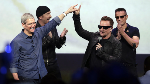 FILE - In this Sept. 9, 2014 file photo, Apple CEO Tim Cook, left, greets Bono from the band U2 after they preformed at the end of the Apple event on Tuesday, Sept. 9, 2014, in Cupertino, Calif. Apple unveiled a new Apple Watch, the iPhone 6 and Apple Pay