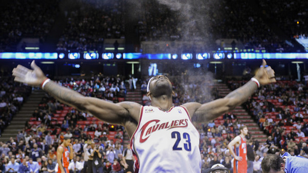 FILE - In this Jan. 2, 2010, file photo, Cleveland Cavaliers' LeBron James throws powder into the air before an NBA basketball game against the New Jersey Nets in East Rutherford, N.J. Although hes skipped a popular pregame ritual lately in which he s