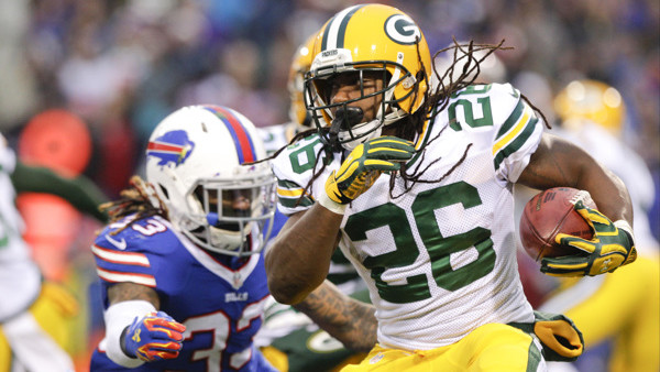 Green Bay Packers running back DuJuan Harris (26) runs away from Buffalo Bills' Ron Brooks (33) during the second half of an NFL football game Sunday, Dec. 14, 2014, in Orchard Park, N.Y. (AP Photo/Bill Wippert)