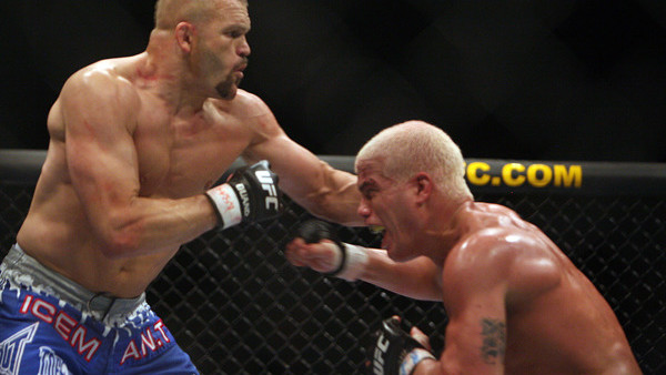 Ultimate Fighting Championship light heavyweight champion Chuck Liddell, left, and Tito Ortiz, right, spar in the second round of their fight in Las Vegas on Saturday, Dec. 30, 2006. Liddell won to retain his title. (AP Photo/Marlene Karas)