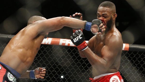 Daniel Cormier, left, punches Jon Jones during their light heavyweight title mixed martial arts bout at UFC 182, Saturday, Jan. 3, 2015, in Las Vegas. (AP Photo/John Locher)