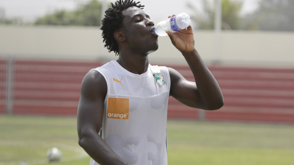 Ivory Coast player, Wilfried Bony, cool off with a bottle of water after a soccer training session at La Paz Stadium in Malabo, Equatorial Guinea, Saturday, Jan. 17, 2015. Yaya Toure sat out practice Saturday, three days before the Ivory Coast plays it op