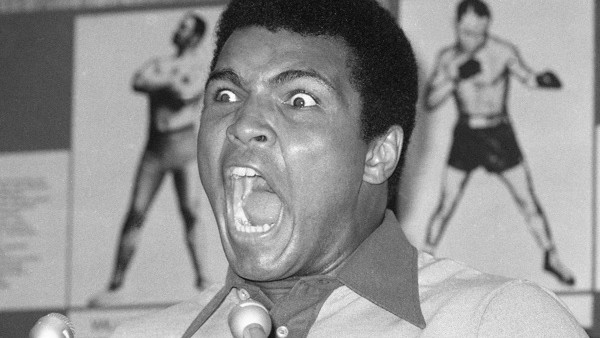 FILE - In this Aug. 29, 1974, file photo, boxer Muhammad Ali makes a face during a press luncheon in New York, to promote the sale of tickets to Madison Square Garden where the battle against George Foreman in Zaire will be shown in October on closed circ