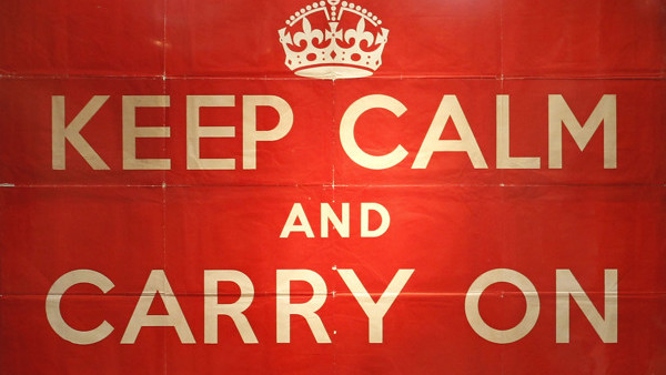 An original 1939 Ministry of Information 'Keep Calm and Carry On' poster, left, is seen on display at Christie's auction house in London, Thursday, Aug. 30, 2012. The poster is to be auctioned in 'The London Sale' on Sept. 3 as is expected to realise a pr