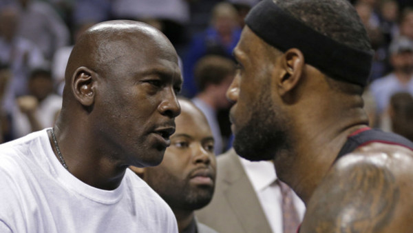 Charlotte Bobcats owner Michael Jordan, left, shakes hands with Miami Heat's LeBron James, right, after Game 4 of an opening-round NBA basketball playoff series in Charlotte, N.C., Monday, April 28, 2014. The Heat won 109-98, sweeping the series. (AP Phot