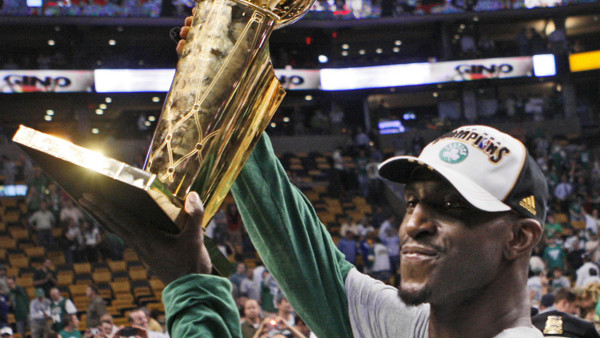 Boston Celtics' Kevin Garnett holds the NBA Championship trophy after the Celtics' 131-92 win over the Los Angeles Lakers in Game 6 of the NBA basketball finals Tuesday, June 17, 2008, in Boston. (AP Photo/Elise Amendola)