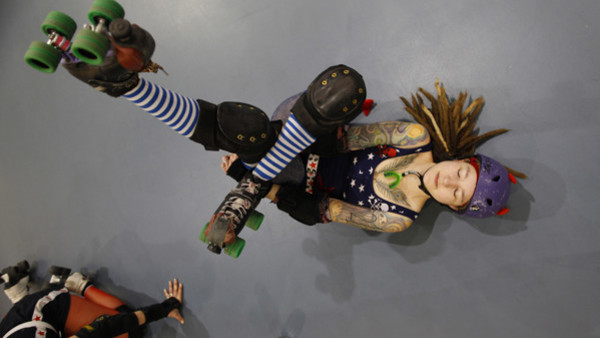 A member of the Shevil Knevils roller derby team stretches before a Brewcity Bruisers bout, Saturday, Jan. 16, 2010, in Franklin, Wis. (AP Photo/Jeffrey Phelps) HOLD FOR SHOUN
