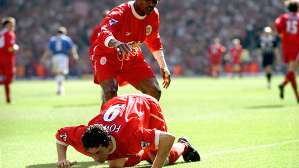 Liverpool's Rigobert Song (standing) congratulates Robbie Fowler after scoring  their first goal as he pretends to snort cocaine from the touch line, after abuse from the Everton fans