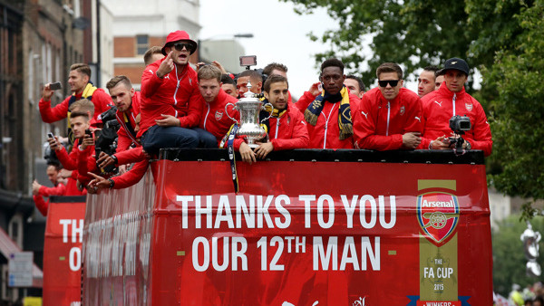 The Arsenal team celebrate winning the FA Cup during their parade through London.