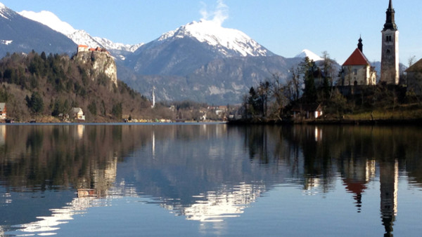 In this photo taken Tuesday, Jan. 27, 2015, shows Lake Bled in Slovenia with a island and the Church of Our Lady on it. Tucked in the southwestern corner of Slovenia, between Austria and Italy, stands a spectacular landscape: a lush tiny island in the mid