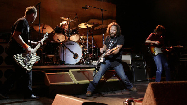 EDITORIAL USE ONLY. Pearl Jam, with lead singer Eddie Vedder (centre), performing on stage at the O2 Shepherds Bush Empire in west London.