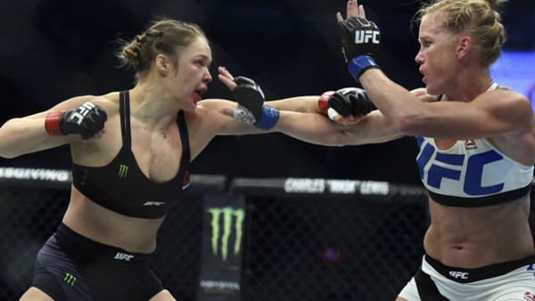 Holly Holm, left, and Ronda Rousey exchange their punches during their UFC 193 bantamweight title fight in Melbourne, Australia, Sunday, Nov. 15, 2015. Holm pulled off a stunning upset victory over Rousey in the fight, knocking out the women's bantamw