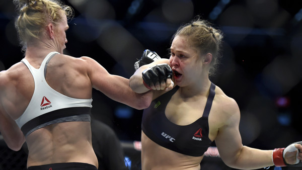 Holly Holm, left, and Ronda Rousey exchange their punches during their UFC 193 bantamweight title fight in Melbourne, Australia, Sunday, Nov. 15, 2015. Holm pulled off a stunning upset victory over Rousey in the fight, knocking out the women's bantamw