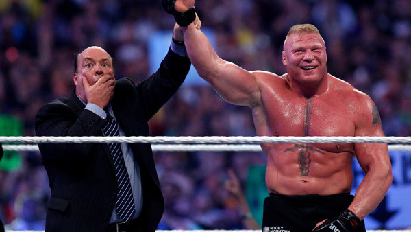 Paul Heyman, left, celebrates with Brock Lesnar after his win over the Undertaker during Wrestlemania XXX at the Mercedes-Benz Super Dome in New Orleans on Sunday, April 6, 2014. (Jonathan Bachman/AP Images for WWE)