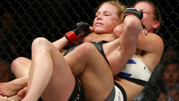 Miesha Tate, right, chokes Holly Holm during their UFC 196 womens bantamweight mixed martial arts match Saturday, March 5, 2016, in Las Vegas. Tate won by submission. (AP Photo/Eric Jamison)
